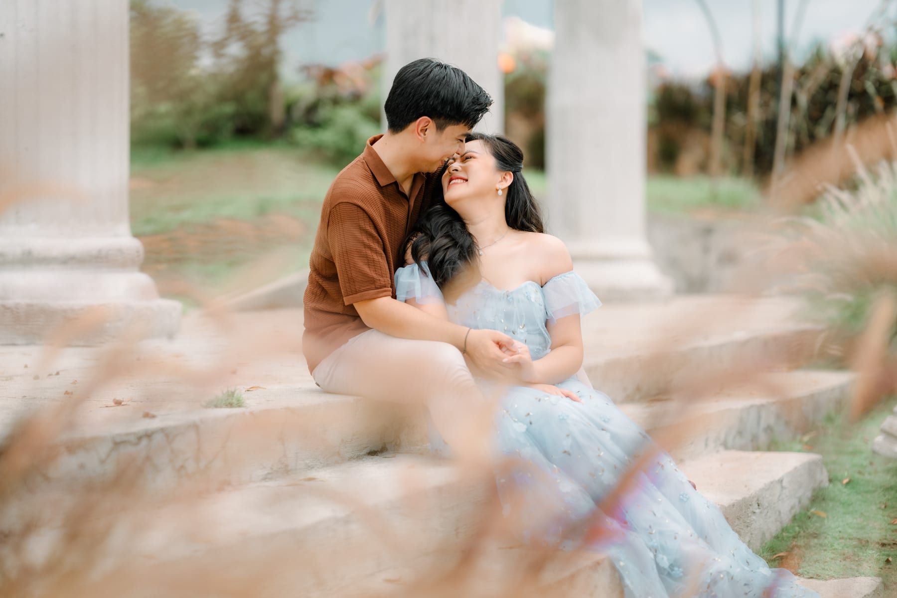 Luis and Tricia on the steps by the white columns